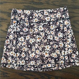 Girl's Athleta Black Floral Mini Skirt with White Daisies and Orange Centers